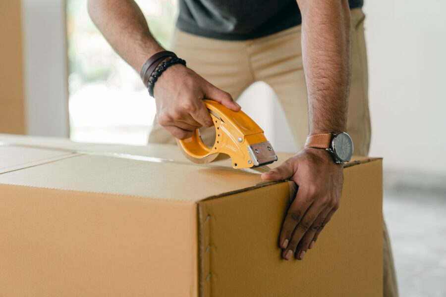 a person packing things into boxes for storage
