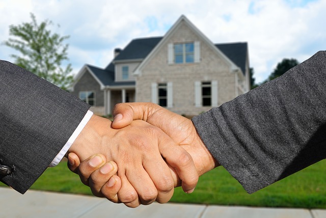 The home seller and the home buyer shake hands.