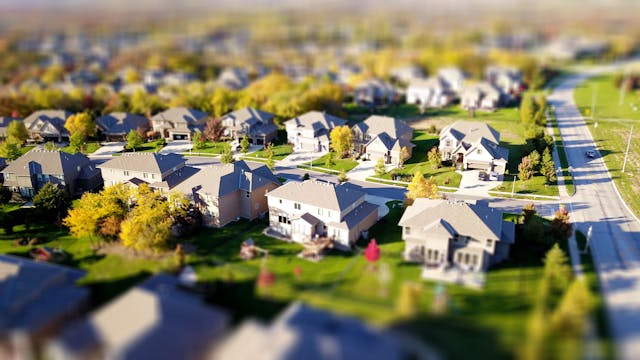 An aerial view of a suburban neighborhood with greenery.